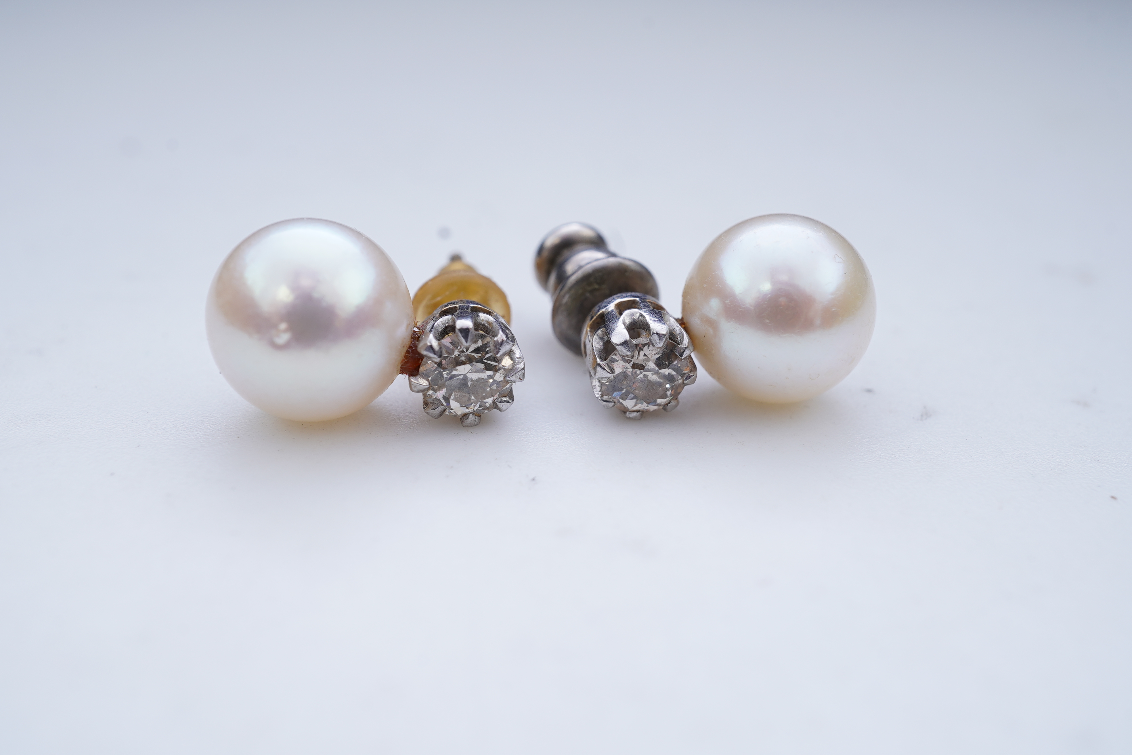 A pair of cultured pearl and diamond earrings